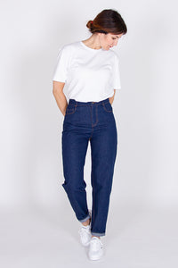 Woman wearing the Sunshine Jeans sewing pattern from I AM Patterns on The Fold Line. A jeans pattern made in denim, twill, corduroy, cotton velvet, linen, serge (chino) or gabardine fabrics, featuring a tapered leg, Italian pockets, coin pocket, back patc