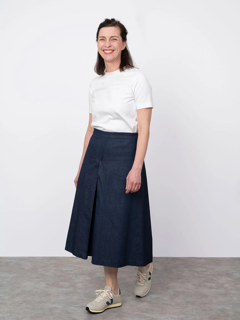 Woman wearing the Culottes sewing pattern from The Assembly Line on The Fold Line. A culottes pattern made in light to mid weight fabrics, featuring a high-waist, wide-leg, box pleats mid-front and mid-back, side pockets and left side zipper opening.