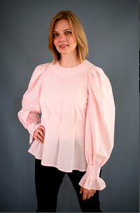 Woman wearing the Tasha Blouse sewing pattern from Lenaline Patterns on The Fold Line. A blouse pattern made in cotton poplin, satin, jersey, linen or viscose fabrics, featuring puff sleeves with gathers at the top and wrist, wrist frill, front and back w