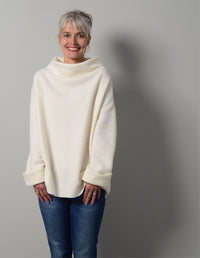 Woman wearing the Big Easy Top sewing pattern from The Maker's Atelier on The Fold Line. A top pattern made in microfleece, bonded jerseys, boiled and felted wools fabrics, featuring an oversized boxy silhouette, grown-on funnel neck, and long sleeves wit