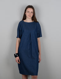 Woman wearing the Pleat Detail Dress sewing pattern from The Maker's Atelier on The Fold Line. A dress pattern made in cotton shirtings, chambrays, linens, or broderie anglaise fabrics, featuring a one pattern piece sleeve and body, centre front inverted 