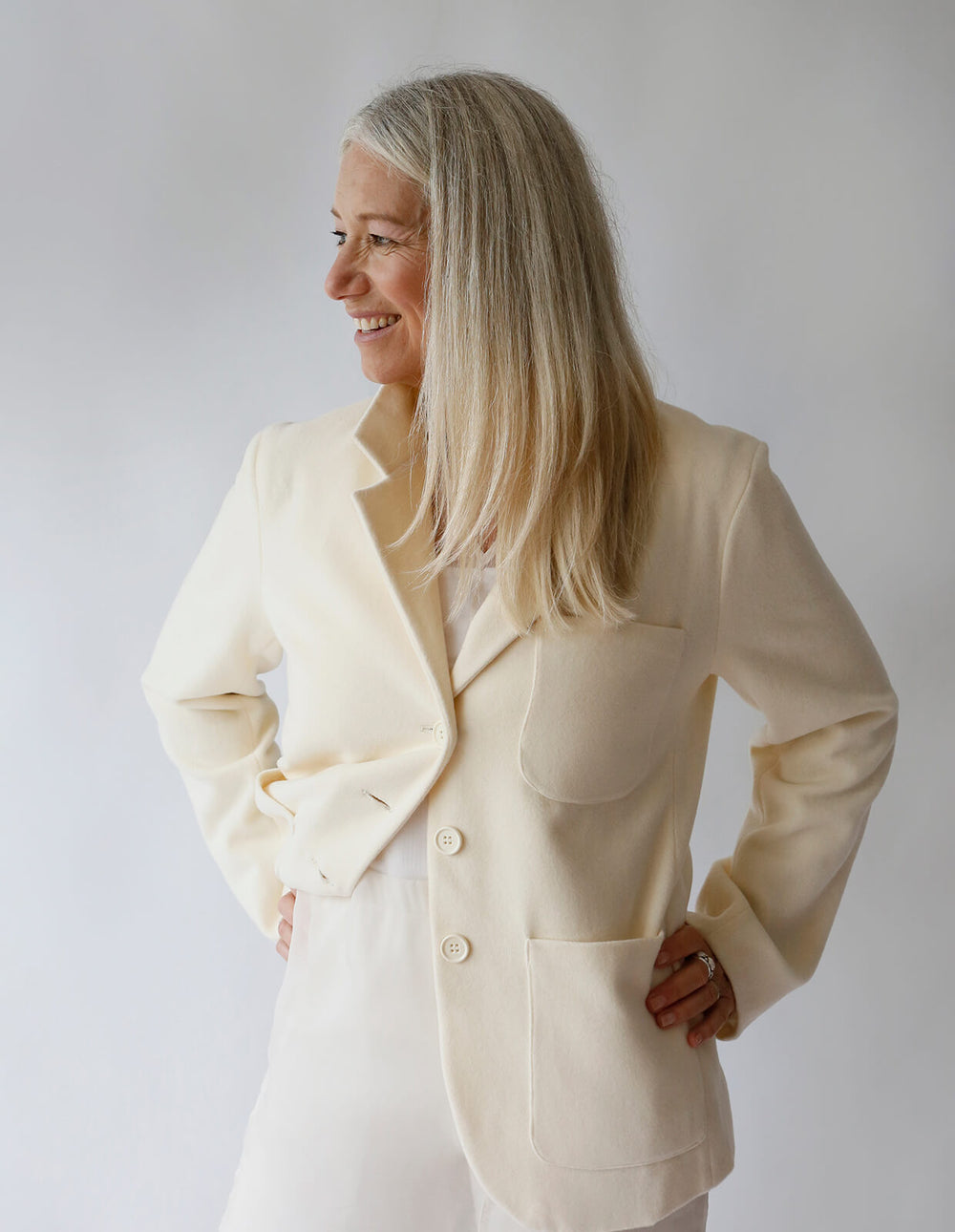 Woman wearing Blazer sewing pattern from The Maker's Atelier on The Fold Line. A blazer pattern made in linen, denim, medium weight cottons and lightweight wool fabrics, featuring a classic men’s style with collar, stand, lapels, patch pockets, front butt