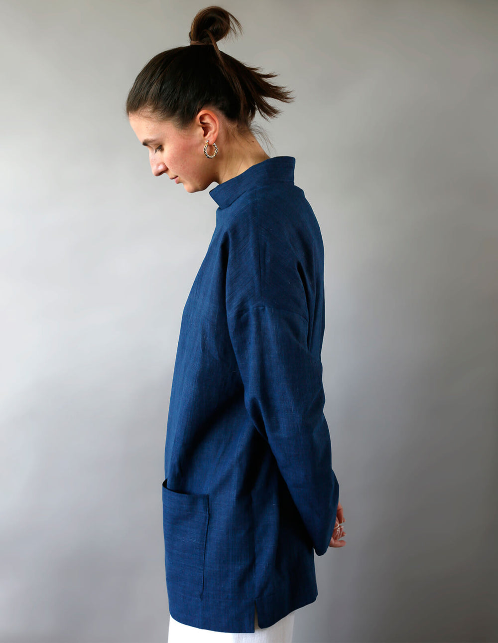 Woman wearing the Maker's Top sewing pattern from The Maker's Atelier on The Fold Line. A top pattern made in cotton, linen, denim, chambray, tencel, viscose or babycord fabrics, featuring a relaxed fit, stand collar, front patch pockets, full length slee