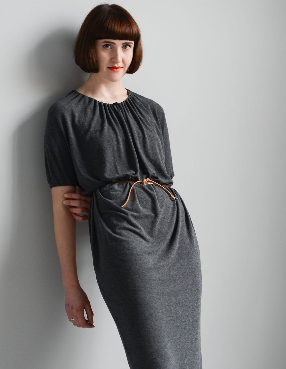 Woman wearing the Drawstring-neck Dress sewing pattern from The Maker's Atelier on The Fold Line. A dress pattern made in fluid drapey fabrics, woven or jersey, viscose mixes, silks and crepes fabrics, featuring a relaxed fit, grown on short sleeves with 