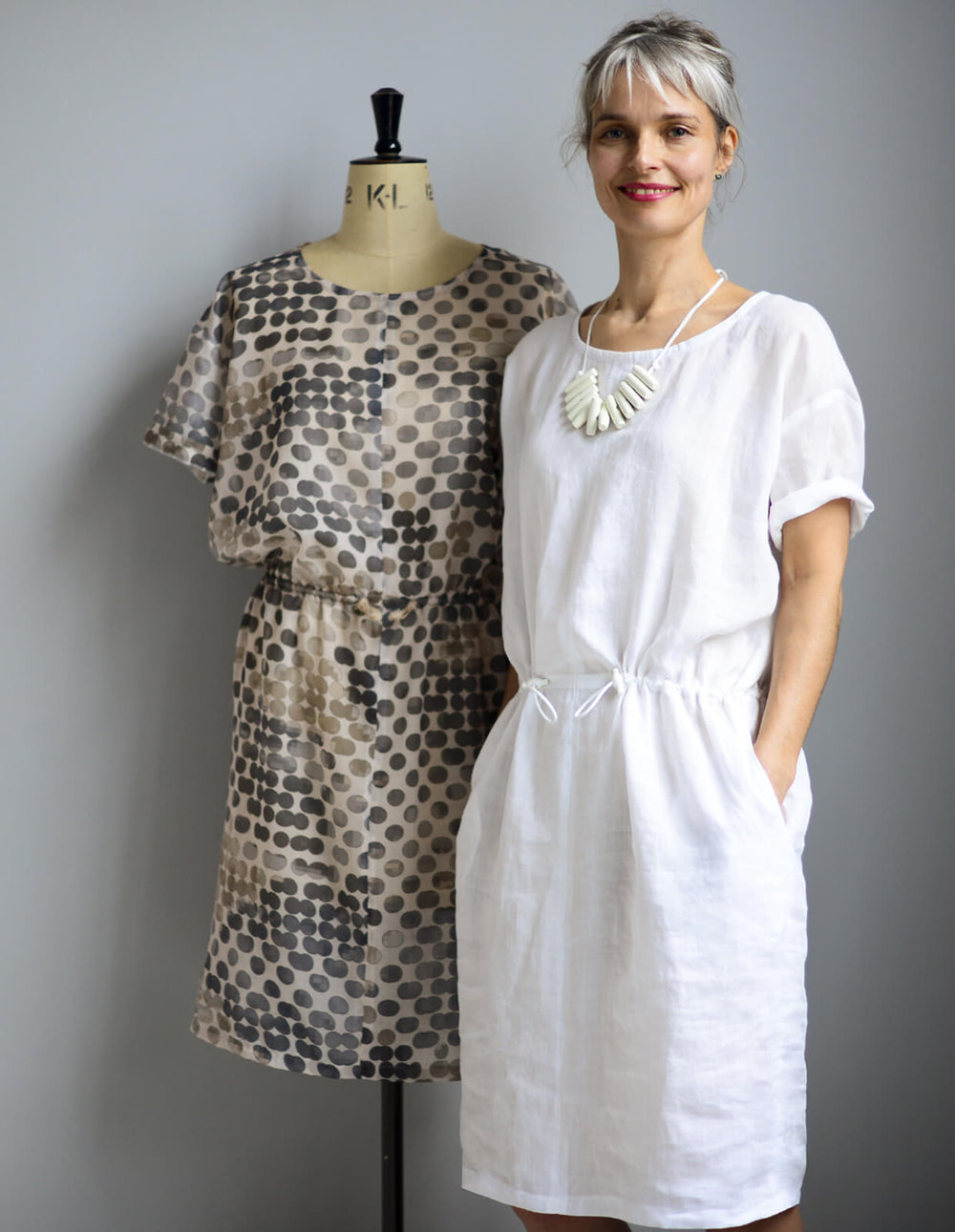 Woman wearing the Utility Dress sewing pattern from The Maker's Atelier on The Fold Line. A dress pattern made in cottons, linens, parachute silks and viscose fabrics, featuring a pull-on, drop-waist with drawstring, loose-fitting, round neckline and knee