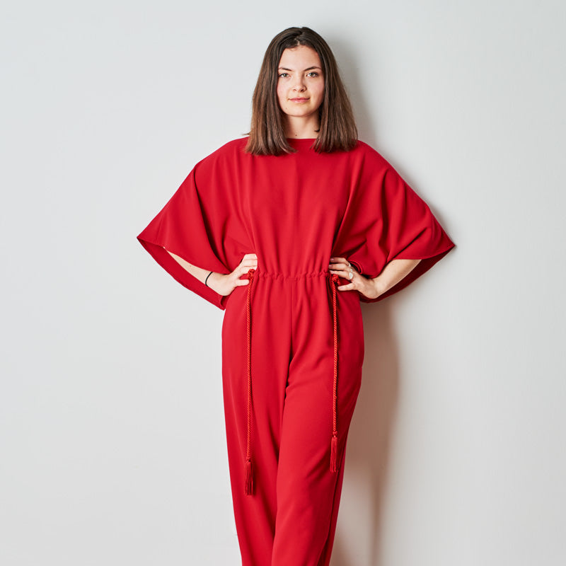 Woman wearing the Madeline Robertson Jumpsuit sewing pattern from The Maker's Atelier on The Fold Line. A jumpsuit dress pattern made in light to medium weight fluid woven fabrics, featuring butterfly sleeves, drawstring waist, back neck button and loop c