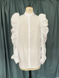 Mannequin wearing the TPCSH3 Angel Wing Shirt sewing pattern from Trend Patterns on The Fold Line. A shirt pattern made in cotton poplin fabrics, featuring a front placket, curved hem, shirt cuff, narrow stand collar and full gathered sleeve.