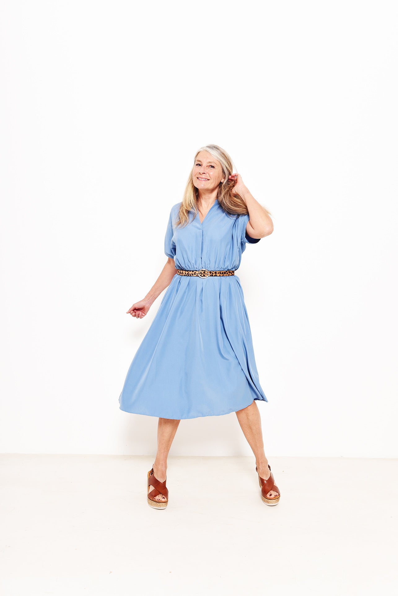 Women wearing the Taylor Dress sewing pattern from Fibre Mood on The Fold Line. A dress pattern made in cotton, viscose, linen, polyester blends or light wool fabrics, featuring shaped sleeves with sleeve trim, a slot neckline with a slight fold, A-line s