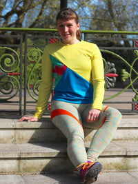 Woman wearing the Tessellate Tee sewing pattern from Fehr Trade on The Fold Line. A T shirt pattern made in cotton jersey, wool jersey, ponte jersey, sweatshirting, French terry, or supplex Lycra fabric, featuring a long sleeve, banded round neck, asymmet