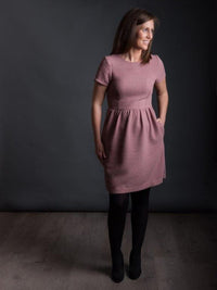 Woman wearing The Day Dress sewing pattern from The Avid Seamstress on The Fold Line. A dress pattern made in light to medium weight fabrics, featuring a fitted bodice, round neckline, gathered skirt, in-seam pockets, short sleeves, invisible back zip clo