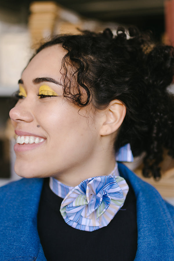 Woman wearing the Rose Necklace sewing pattern from JULIANA MARTEJEVS on The Fold Line. A choker pattern made in cotton poplin fabrics, featuring a front ruffled rose and back bow.