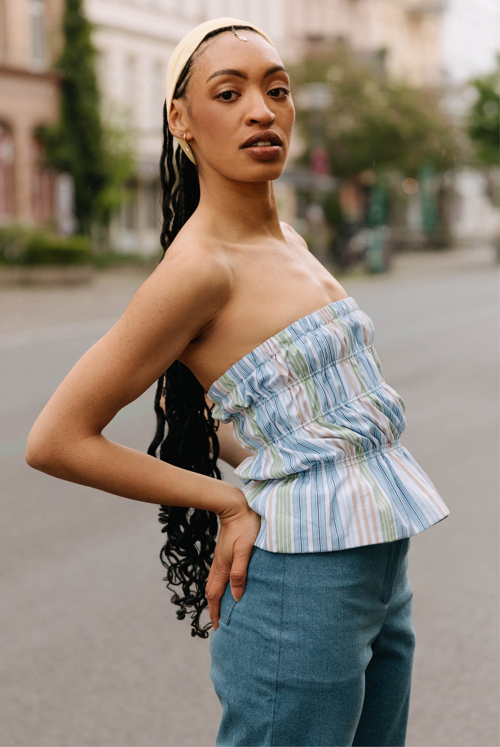 Woman wearing the Zola Top sewing pattern from JULIANA MARTEJEVS on The Fold Line. A reversible ruched tube top made in cotton poplin.