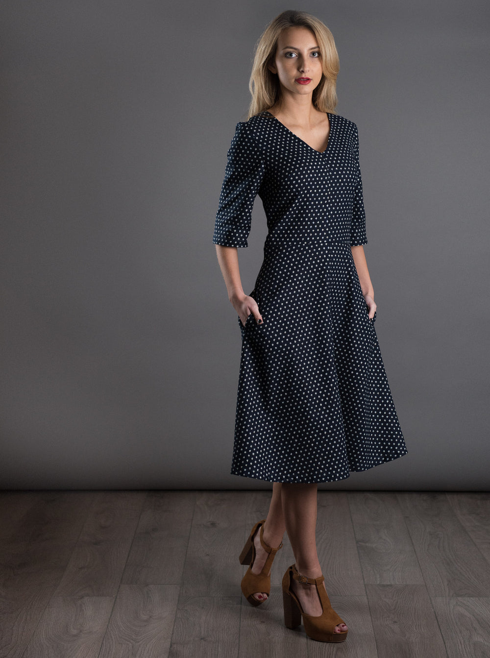 Woman wearing The A-Line Dress sewing pattern from The Avid Seamstress on The Fold Line. An A-line dress pattern made in chambray, crepes, silk, viscose or cottons fabrics, featuring a fitted bodice, elbow length sleeves, V-neckline, in-seam pockets, knee