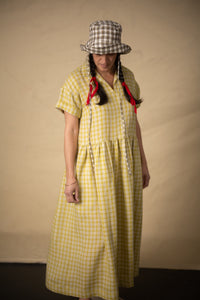 Woman wearing the Factory Dress Gathered Skirt Hack sewing pattern from Merchant & Mills on The Fold Line. A dress pattern made in linen, linen blends, tencel, cotton chambray, very fine wool or corduroy fabric, featuring a relaxed oversized silhouette, collar, short sleeves, gathered skirt, and pockets.