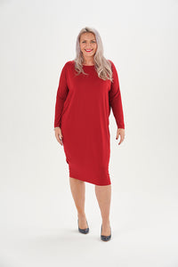 Woman wearing the Thea Dress sewing pattern from Sew Over It on The Fold Line. A knit dress pattern made in lightweight ponte di roma or medium weight viscose jersey fabrics, featuring a cocoon shape, long sleeves, boat neckline, exaggerated batwing drop-