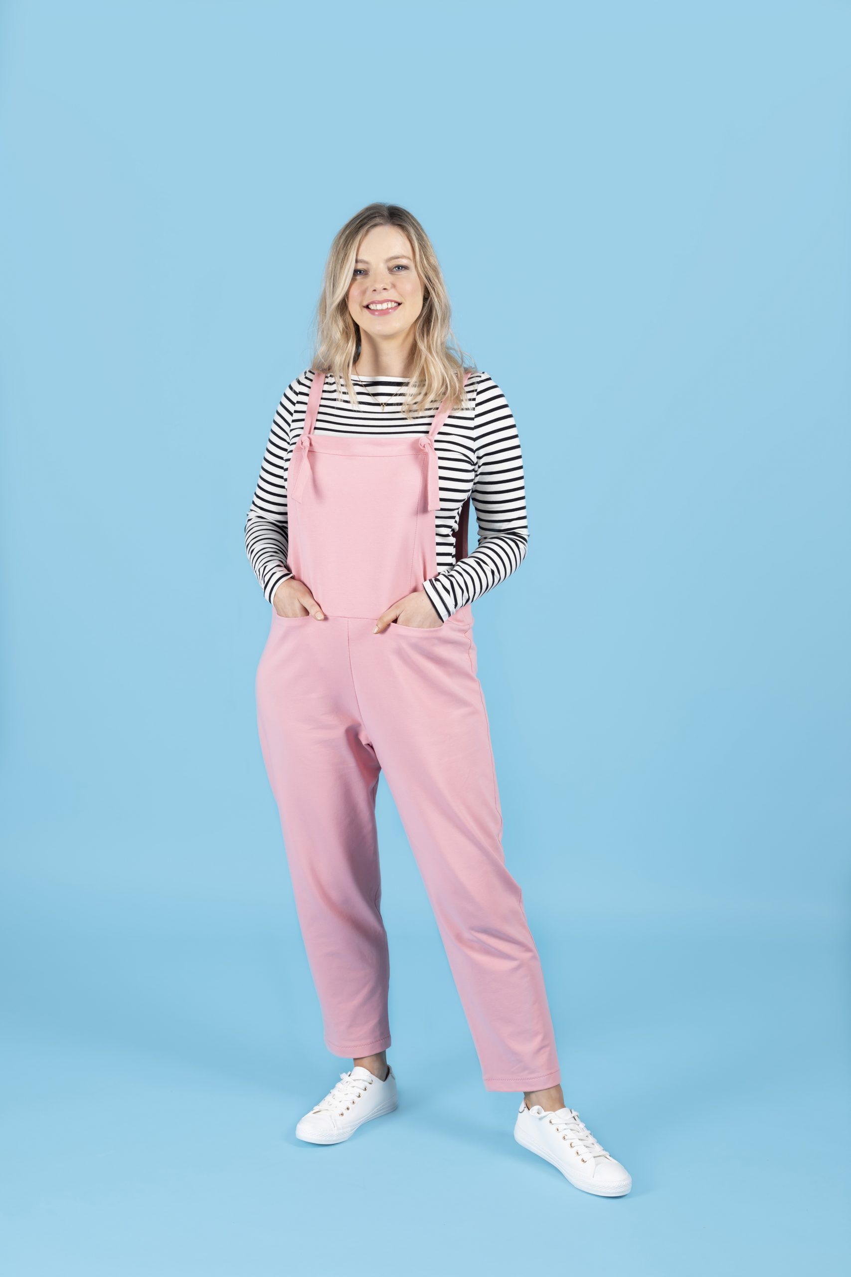 Woman wearing the Erin Dungarees sewing pattern from Tilly and the Buttons on The Fold Line. A dungarees pattern made in French terry, ponte roma, needlecord, linen, chambray, soft twill or viscose (rayon) fabrics, featuring a full length leg, bib, adjust