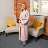 Woman wearing the Titania Robe sewing pattern from Sew Me Something on The Fold Line. A bath robe pattern made in linen, viscose, cotton or cotton waffle fabrics, featuring a relaxed fit, front patch pockets, full length sleeves, self-fabric tie belt, bel