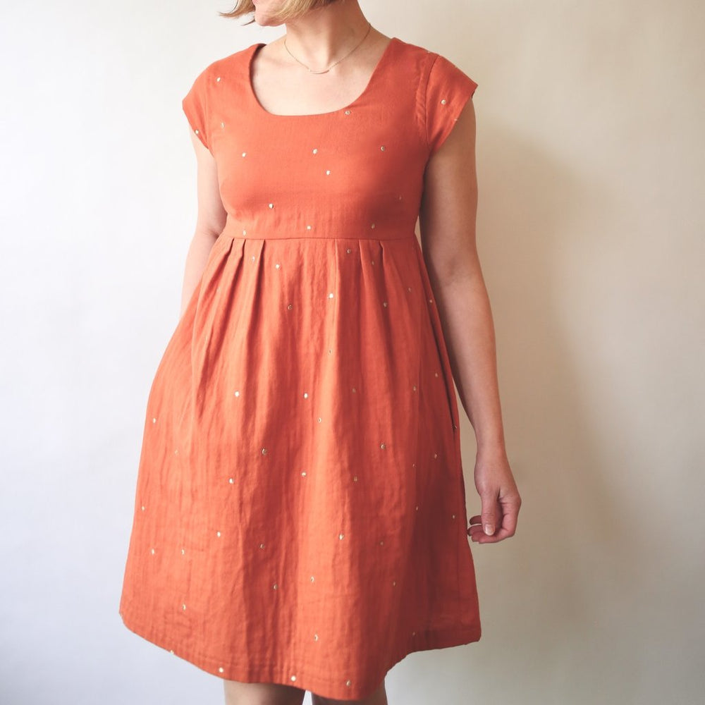 Woman wearing the Trillium Dress sewing pattern from Made by Rae on The Fold Line. A pullover dress pattern made in cotton, cotton blends, voile, lawn, double gauze, quilting cotton, poplin, chambray, or rayon challis fabric, featuring a cut-out scoop nec