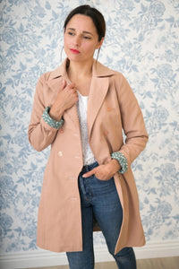 Woman wearing the Tsar Coat or Jacket sewing pattern from Maison Fauve on The Fold Line. A coat pattern made in gabardine, wool cloth, jacquard or velvet fabrics, featuring a collar and lapels, asymmetrical double breasted closure, side pockets, belt and 