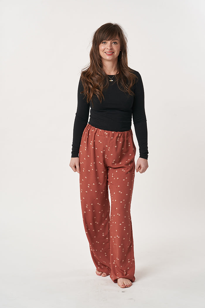 Woman wearing the Ultimate Pyjamas sewing pattern from Sew Over It on The Fold Line. A PJ trouser pattern made in lightweight cotton or cotton lawn fabrics, featuring wide-legs and elasticated waistband with drawstring.