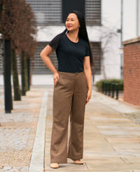 Woman wearing the Upland Trousers sewing pattern by Itch to Stitch. A trouser pattern made in linen, linen mix, twill, corduroy, suiting or poplin fabrics, featuring a high rise, no waistband, fitted through the waist and hip and relaxed at the thighs and