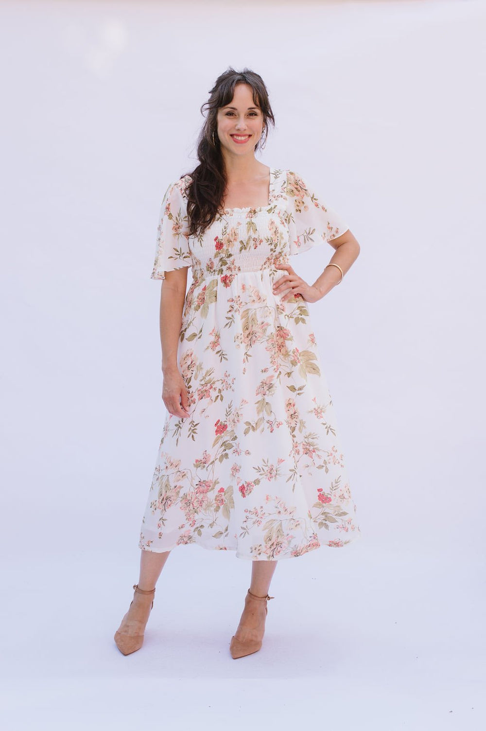Woman wearing the Sofia Dress sewing pattern from Victory Patterns on The Fold Line. A dress pattern made in cotton, gingham, broadcloth, rayon, linen, single gauze, or crepe fabrics, featuring an elasticated waist length shirred bodice, square neckline, 