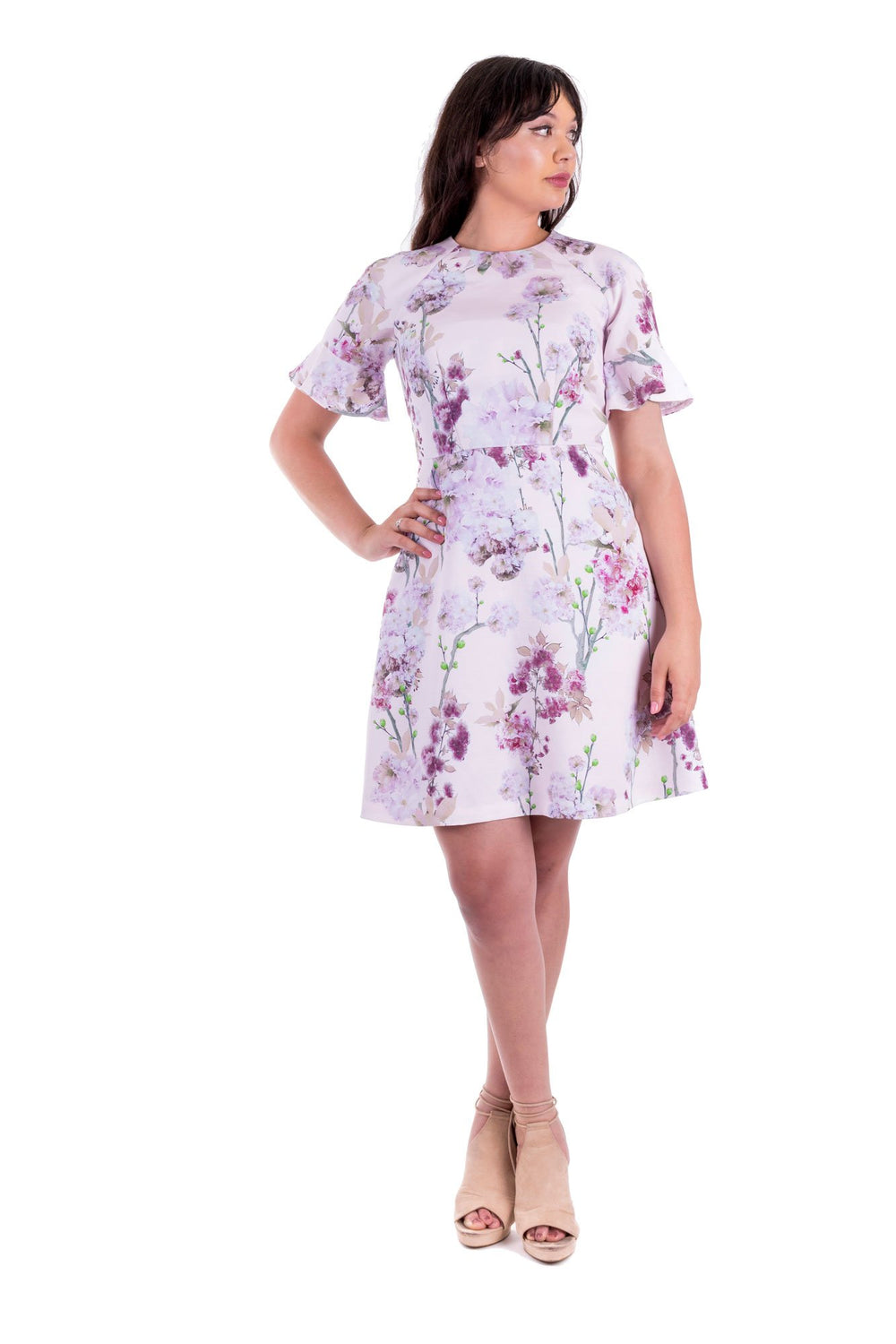 Woman wearing the Valerie Dress sewing pattern by Forget-me-not Patterns. A dress pattern made in viscose/rayons, wools, cottons or linen fabrics, featuring raglan sleeves, fitted bodice, A-line skirt, slash pockets and short sleeves finished with a floun