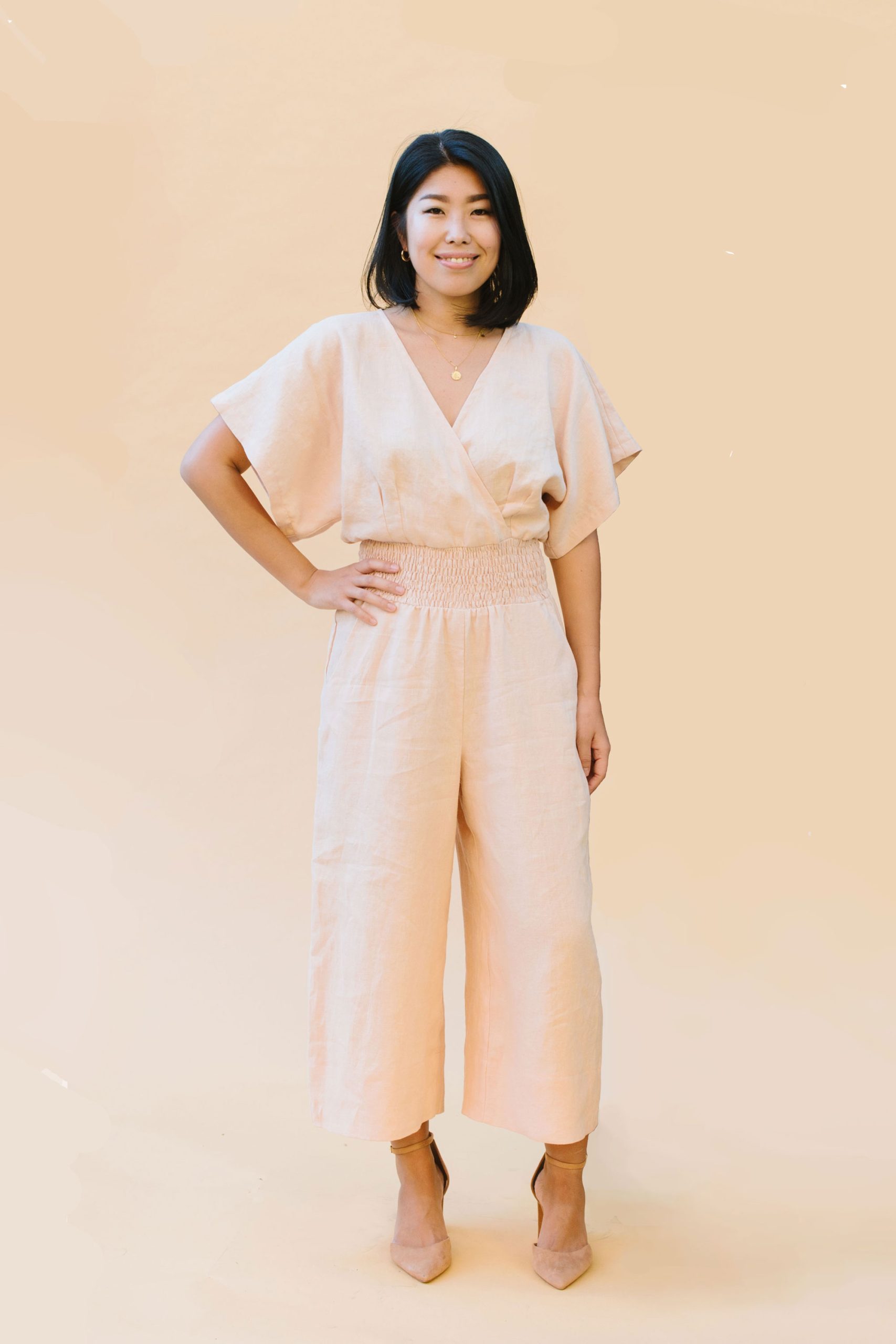 Woman wearing the Rowena Jumpsuit sewing pattern from Victory Patterns on The Fold Line. A jumpsuit pattern made in linen, chambray, viscose, tencel or silk fabrics, featuring a relaxed fit, wide elbow-length grown-on sleeves, overlapping front and back b