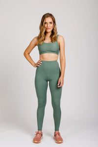 Woman wearing the Mini Virginia Leggings sewing pattern from Megan Nielsen on The Fold Line. A leggings pattern made in stretch fabrics, featuring an elasticated waist, narrow waistband, and full-length leg.