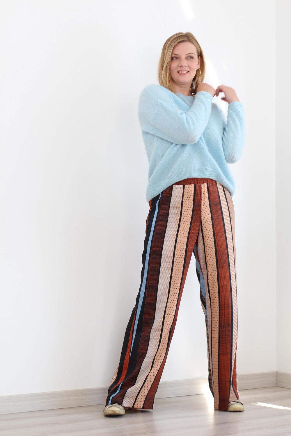 Woman wearing Vlad Trousers sewing pattern from Lenaline Patterns on The Fold Line. A trouser pattern made in linen, viscose, jersey with only width wise stretch, velvet, cotton twill, flannel or gabardine fabrics, featuring a wide leg, elasticated waist 
