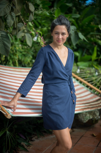 Woman wearing the Vondel Wrap Dress sewing pattern from Halfmoon Atelier on The Fold Line. A wrap dress pattern made in double gauze, crepe, silk, Tencel, rayon, linen, shirting or voile fabrics, featuring a deep V neck, long waist tie, one-piece shoulder