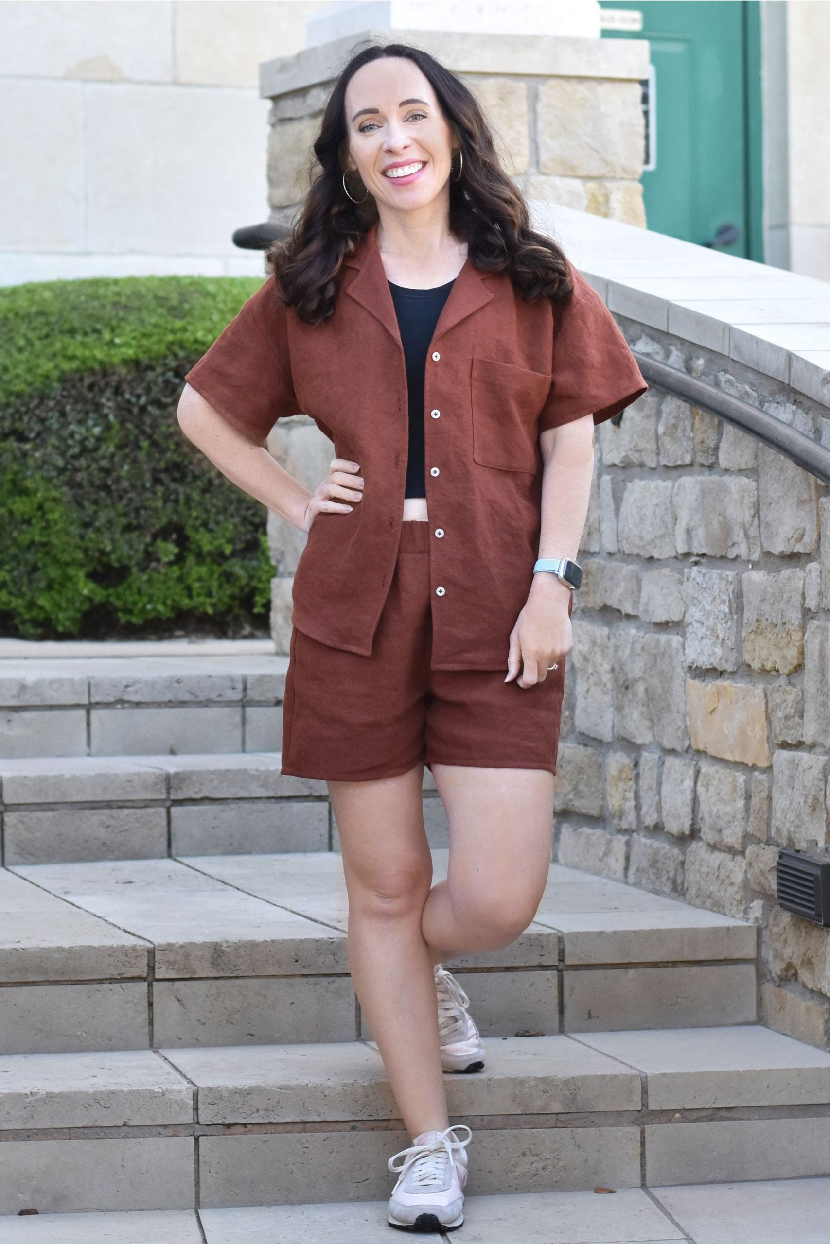 Woman wearing the Camp Shirt and Shorts sewing pattern from Wardrobe by Me on The Fold Line. A shirt and shorts pattern made in cotton, viscose, linen or silk fabrics, featuring a relaxed fit, button front closure, convertible collar, dropped shoulders, s