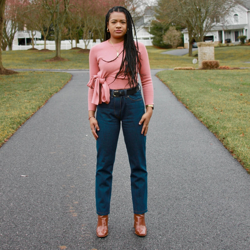 Woman wearing the WBM Women's Jeans #1 sewing pattern from Wardrobe by Me on The Fold Line. A trouser pattern made in denim or canvas fabrics, featuring a straight-leg, curved waistband, front fly with zipper, curved front pockets, coin pocket, pointed ba