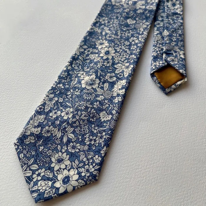 Photo showing the Warwick Tie sewing pattern from Maven Patterns on The Fold Line. A tie pattern made in light to mid-weight woven fabrics featuring a traditional style with contrast lining.