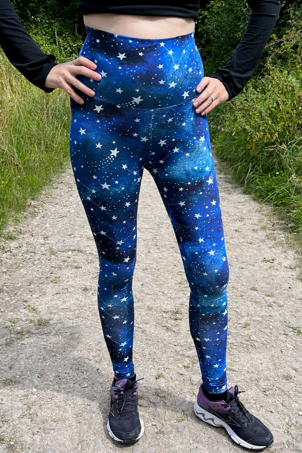 Woman wearing the Jupiter Leggings sewing pattern from Waves & Wild on The Fold Line. A leggings pattern made in 4-way stretch knit fabrics, featuring a full-length leg, curvy fit, side leg phone pocket, colour blocking options, and wide elasticated waist