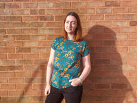 Woman wearing the Women’s Victory Dolman T-shirt sewing pattern from Waves & Wild on The Fold Line. A T-shirt pattern made in knit fabric such as cotton/lycra jersey, rayon/lycra jersey, or bamboo/lycra jersey, featuring a round neckline and short dolman 