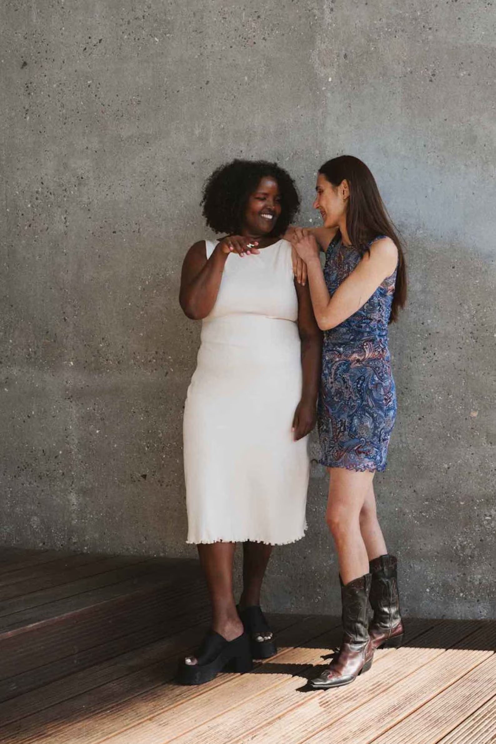 Women wearing the Wavy Hem Dress sewing pattern from Puff and Pencil on The Fold Line. A sleeveless dress pattern made in stretch mesh, fine cotton rib, and jersey fabrics, featuring a body-hugging silhouette, boat neck, mini or mid-length and wavy hem li