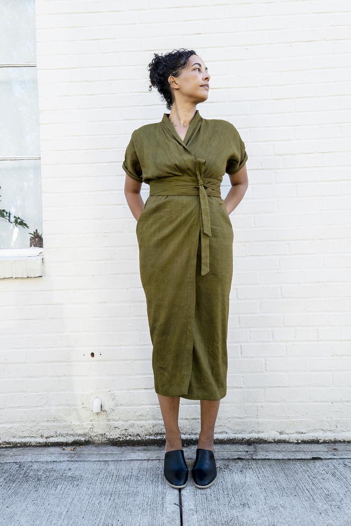 Woman wearing the Wildwood Wrap Dress sewing pattern from Sew House Seven on The Fold Line. A wrap dress pattern made in linen blends, cotton lawn, dress weight cottons, rayon or silk fabrics, featuring a shawl collar, waist and shoulder pleats, front sla