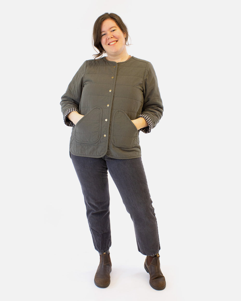 Woman wearing the Unisex Wildwood Jacket sewing pattern from Helen's Closet on The Fold Line. A Quilted Jacket pattern made in cotton, flannel, linen, wool, and hemp fabrics, featuring overlapping shoulder and side seams, bias taped edges, patch pockets, 