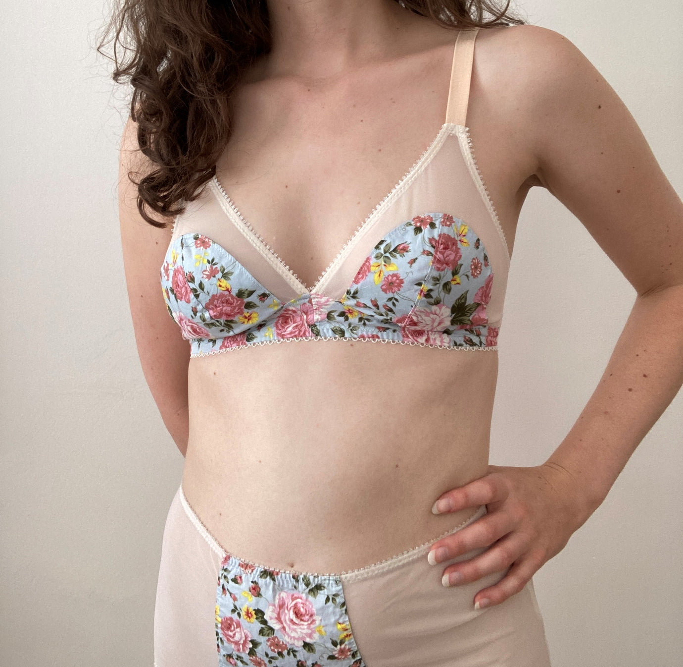 Woman wearing the Willow Soft Cup Bra sewing pattern from Sew Projects on The Fold Line. A bra pattern made in cotton, lace, tulle, satin or duoplex fabrics, featuring a high rigid cup, stretch neckline, adjustable shoulder straps, and a 2 hook and loop b