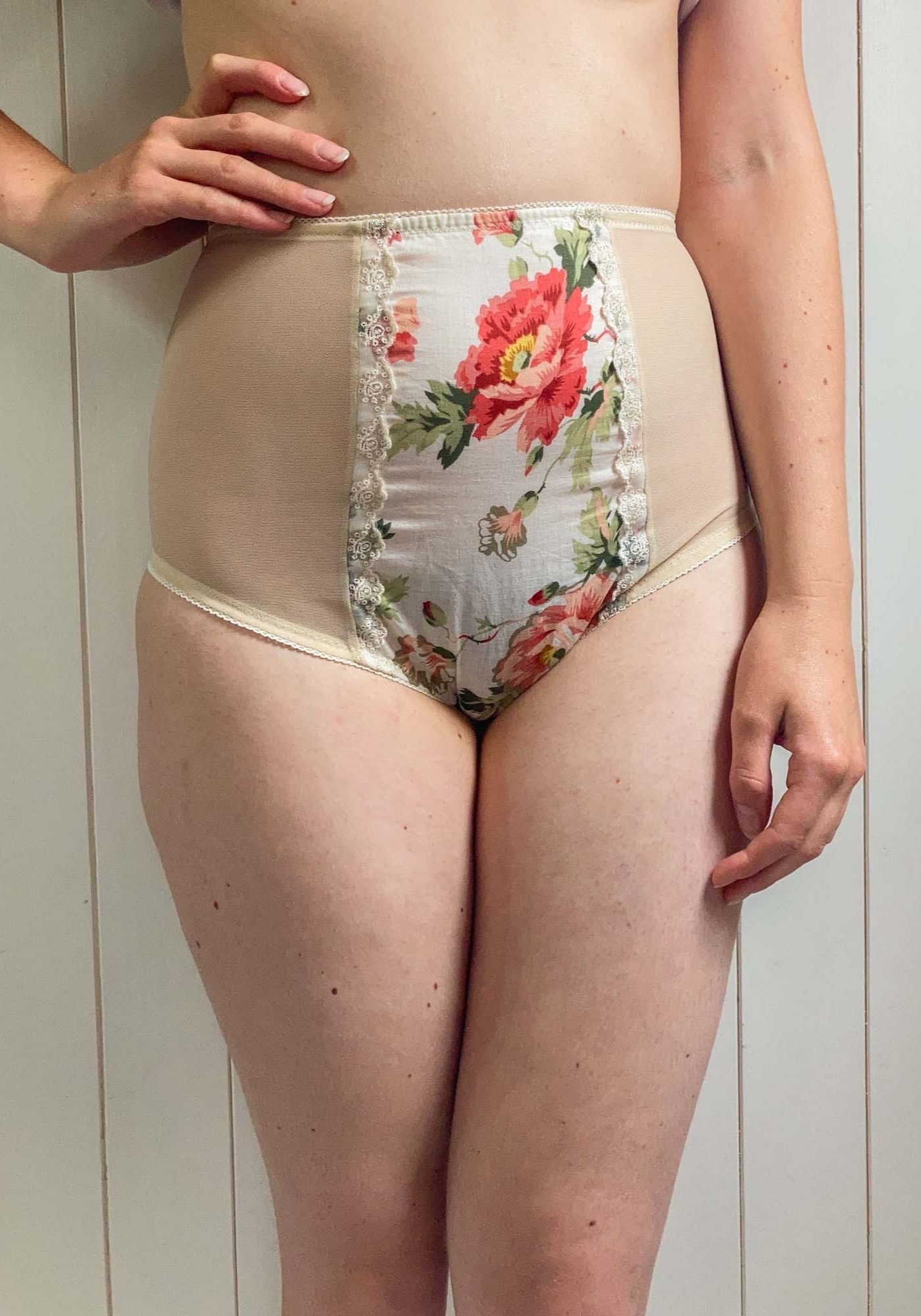 Woman wearing the Willow Knicker sewing pattern from Sew Projects on The Fold Line. A briefs pattern made in jersey, stretch satin, stretch mesh, stretch lace for the side and back. Cotton, lace, embroidery, silk, satin fabrics for the centre panel, featu