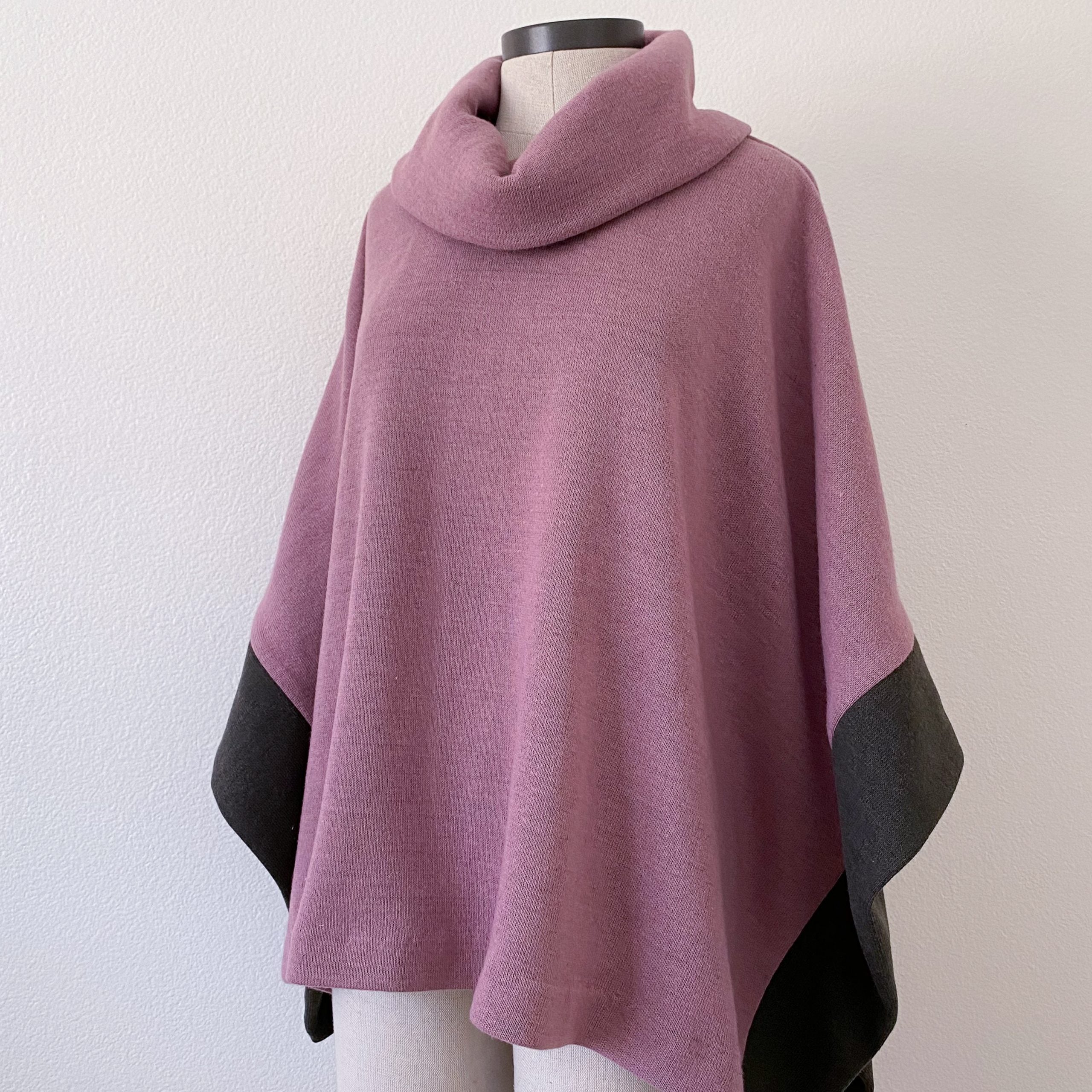 Mannequin wearing the Wintertide Poncho sewing pattern from Blue Dot Patterns on The Fold Line. A poncho pattern made in medium to heavy weight knits including ponte, sweater knit, sweatshirt fleece and French terry fabrics, featuring a cowl neck with ope