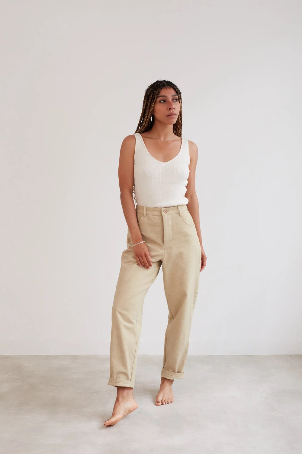 Woman wearing the Worker Trousers sewing pattern from The Modern Sewing Co on The Fold Line. A trouser pattern made in heavy to mid-weight twills, drills, denims or canvas fabrics, featuring a slight balloon leg tapering in at the ankle, fitted at the hip
