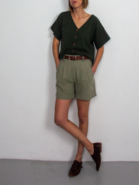 Woman wearing the Xanelé Shorts sewing pattern from French Navy on The Fold Line. A shorts pattern made in linen, linen blends, hemp, tencel or chambray fabrics, featuring an elasticated waistband with belt loops, pleated front, cuffed hem and mid-thigh l