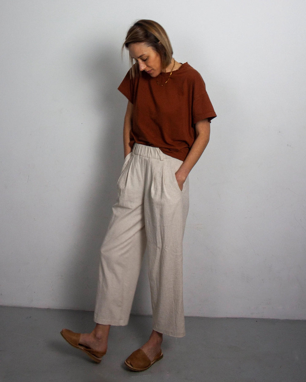 Women wearing the Xanelé Longs sewing pattern from French Navy on The Fold Line. A shorts to trousers extension pattern made in linen, hemp, tencel, wool or chambray fabrics, featuring an elastic waist, angled front pockets, relaxed fit, slightly cropped 