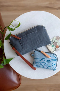 Photo showing the Yarrow Wristlet and Pouch sewing pattern from Noodlehead on The Fold Line. A wristlet and pouch bag pattern made in canvas, cotton, cotton/linen, oilskin or cork fabrics, featuring a wristlet with an interior zippered pocket and card slo