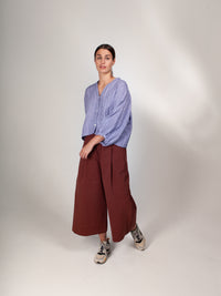 Woman wearing the ZW Block Pant sewing pattern from Birgitta Helmersson on The Fold Line. A wide legged, relaxed fitting trouser pattern made in medium-heavy weight woven cotton and linen or light-mid weight wool fabrics, featuring a waistband with insert