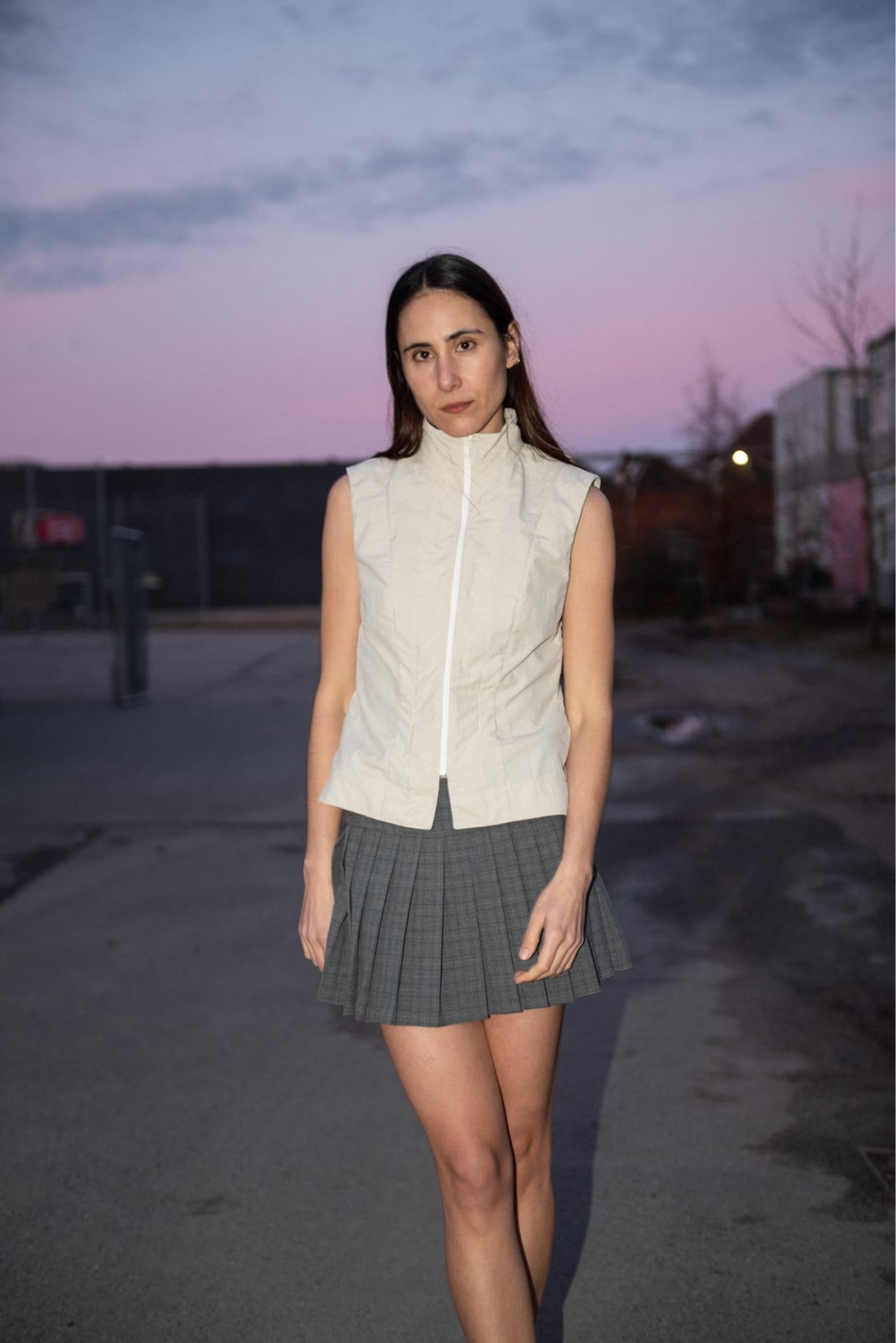 Woman wearing the Zip Vest sewing pattern from Puff and Pencil on The Fold Line. A vest pattern made in denim, canvas, wool, faux leather, or twill fabric, featuring a slightly fitted silhouette, high collar, and front zipper.