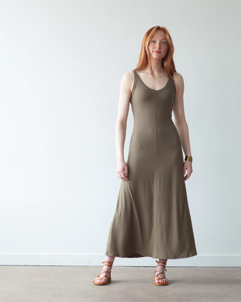 Woman wearing the Zoey Dress sewing pattern from True Bias on The Fold Line. A dress pattern made in cotton/spandex blends, T-shirt jersey or rib knits fabrics, featuring a fit and flare silhouette, soft front V-neck, low scooped back neckline, narrow sho