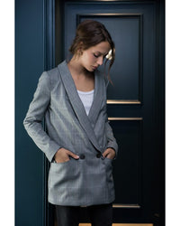 Woman wearing the Amsterdam Blazer sewing pattern from Orageuse on The Fold Line. A double breasted jacket pattern made in fine wool/suiting, velvet, gabardine, cotton or linen fabrics, featuring a straight loose silhouette, shawl collar, princess seams, 